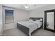 Bedroom with dark wood bed frame, ceiling fan, decorative mirror, and window with blinds at 23733 S 209Th Pl, Queen Creek, AZ 85142