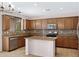 Features include wooden cabinets, granite countertops, stainless steel appliances and a kitchen island at 23733 S 209Th Pl, Queen Creek, AZ 85142