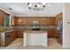 Spacious kitchen featuring a kitchen island, stainless steel appliances, and granite countertops and tile backsplash at 23733 S 209Th Pl, Queen Creek, AZ 85142