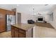Bright and airy living room showcases an island, a black sofa, tv and custom shelving at 23733 S 209Th Pl, Queen Creek, AZ 85142
