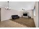 Spacious living room featuring modern lighting, a black leather sofa, and a built-in media center at 23733 S 209Th Pl, Queen Creek, AZ 85142