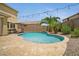 Backyard pool with travertine border, small waterfall, patio lounge, string lights and desert landscaping at 23733 S 209Th Pl, Queen Creek, AZ 85142