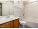 A full bathroom includes a shower-tub combo, tile flooring and a single sink vanity with storage at 2402 E 5Th St # 1411, Tempe, AZ 85288