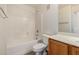 A bright, clean bathroom showcases a tub with tile surround, along with a toilet and vanity at 2402 E 5Th St # 1411, Tempe, AZ 85288