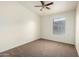 A cozy room has neutral walls, plush carpet, and a ceiling fan with light adding comfort and style at 2402 E 5Th St # 1411, Tempe, AZ 85288