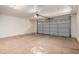 A spacious garage features a grey door, smooth flooring, and ample room for vehicles and storage at 2402 E 5Th St # 1411, Tempe, AZ 85288