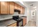 Practical kitchen features plenty of counter space, an electric range, and tiled floors with easy access to a half-bath at 2402 E 5Th St # 1411, Tempe, AZ 85288