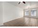 Bright living room featuring tile floors, arched windows, neutral walls, and modern lighting for a comfortable living space at 2402 E 5Th St # 1411, Tempe, AZ 85288