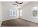Spacious main bedroom with natural light, a ceiling fan, and neutral carpeting for a relaxing private retreat at 2402 E 5Th St # 1411, Tempe, AZ 85288