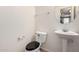 Half-bath features pedestal sink and a round mirror at 2402 E 5Th St # 1411, Tempe, AZ 85288