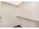 A spacious walk-in closet features wooden rails and white shelving for optimal organization at 2402 E 5Th St # 1411, Tempe, AZ 85288