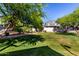 Manicured backyard lawn with mature trees offers shade and serene outdoor space at 2402 E 5Th St # 1411, Tempe, AZ 85288