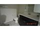 A well-lit bathroom features a dark wood vanity with a white countertop, a standard toilet, and tile floors at 24646 N Barley Rd, Florence, AZ 85132