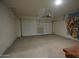 Spacious two-car garage with painted walls, concrete floors, and a roll-up door with electric opener at 24646 N Barley Rd, Florence, AZ 85132
