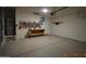 Spacious two-car garage with concrete floor and painted walls, some with graffiti art, plus a utility sink and work bench at 24646 N Barley Rd, Florence, AZ 85132
