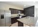 Spacious kitchen with stainless steel appliances, granite counters, and dark wood cabinets at 24646 N Barley Rd, Florence, AZ 85132