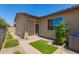 Backyard featuring a covered patio, flower beds, artificial turf, and beautiful landscaping at 24746 N 171St Ln, Surprise, AZ 85387