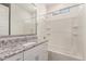 Bathroom featuring a tub with shower, granite counters, and framed mirror at 24746 N 171St Ln, Surprise, AZ 85387