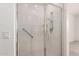 Walk-in shower featuring white subway tile, a glass door, and a handrail at 24746 N 171St Ln, Surprise, AZ 85387