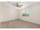 Neutral bedroom with carpet flooring, ceiling fan, and a window with blinds at 24746 N 171St Ln, Surprise, AZ 85387