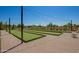 Outdoor bocce ball court with synthetic turf, string lights and comfortable patio seating at 24746 N 171St Ln, Surprise, AZ 85387