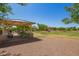 Outdoor community park area with a gazebo, seating, green grass, and views of nearby homes at 24746 N 171St Ln, Surprise, AZ 85387