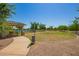 Outdoor community park area with a gazebo, green grass, walking path, and community pool in the background at 24746 N 171St Ln, Surprise, AZ 85387