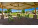 Relaxing seating area inside community gazebo surrounded by landscaped lawn and trees at 24746 N 171St Ln, Surprise, AZ 85387