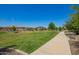 Expansive green space with walking path and mature trees in a well-maintained community at 24746 N 171St Ln, Surprise, AZ 85387