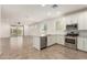 Modern kitchen with white cabinets, granite countertops, and stainless steel appliances at 24746 N 171St Ln, Surprise, AZ 85387