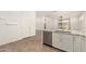 Open-concept kitchen with island, stainless steel dishwasher, and views of the living area at 24746 N 171St Ln, Surprise, AZ 85387