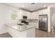 Bright kitchen featuring granite countertops, stainless steel appliances, and white cabinets at 24746 N 171St Ln, Surprise, AZ 85387