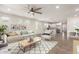 Spacious living room with ample natural light, neutral décor, and seamless flow to the kitchen and dining area at 24746 N 171St Ln, Surprise, AZ 85387