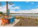 Charming outdoor dining area with colorful seating, lake view, and lush landscaping at 24746 N 171St Ln, Surprise, AZ 85387