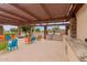 Well-equipped outdoor kitchen and seating area, perfect for entertaining in style at 24746 N 171St Ln, Surprise, AZ 85387