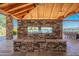 An outdoor kitchen and bar area has amazing lake views at 24746 N 171St Ln, Surprise, AZ 85387