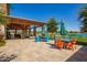 Outdoor seating with colorful chairs overlooks a lake offering a social gathering space at 24746 N 171St Ln, Surprise, AZ 85387