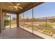 Covered patio featuring nice flooring, flower beds, and an outdoor ceiling fan at 24746 N 171St Ln, Surprise, AZ 85387