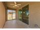 Covered patio featuring screened sliders, ceiling fan, and great flooring at 24746 N 171St Ln, Surprise, AZ 85387