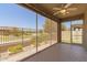 Screened in patio with ceiling fan, nice flooring, and views of the backyard at 24746 N 171St Ln, Surprise, AZ 85387
