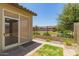 View of the backyard patio with a screened-in porch and a view of the backyard fence at 24746 N 171St Ln, Surprise, AZ 85387