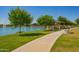 Walkway along the pond offers views of the community clubhouse and gathering spaces at 24746 N 171St Ln, Surprise, AZ 85387