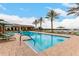 Inviting community pool with lounge chairs and a tranquil lake view at 24746 N 171St Ln, Surprise, AZ 85387