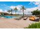 Community pool with clear blue water, lounge chairs, and scenic views at 24746 N 171St Ln, Surprise, AZ 85387