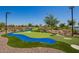 A unique putting course with blue water features and synthetic green turf offers a fun activity at 24746 N 171St Ln, Surprise, AZ 85387