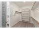 Walk-in closet with shelving and rod for clothing storage at 24746 N 171St Ln, Surprise, AZ 85387