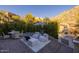 Inviting backyard with outdoor kitchen, dining and lounge seating surrounded by lush desert vegetation at 25555 N Windy Walk Dr # 34, Scottsdale, AZ 85255
