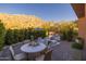 Landscaped backyard with brick patio, outdoor kitchen, dining, lounge seating and desert mountain views at 25555 N Windy Walk Dr # 34, Scottsdale, AZ 85255