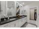 Bathroom featuring double sinks, modern fixtures, and a glimpse into an organized closet at 25555 N Windy Walk Dr # 34, Scottsdale, AZ 85255