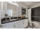 Modern bathroom with a gray countertop, white cabinets, and decorative tile flooring at 25555 N Windy Walk Dr # 34, Scottsdale, AZ 85255